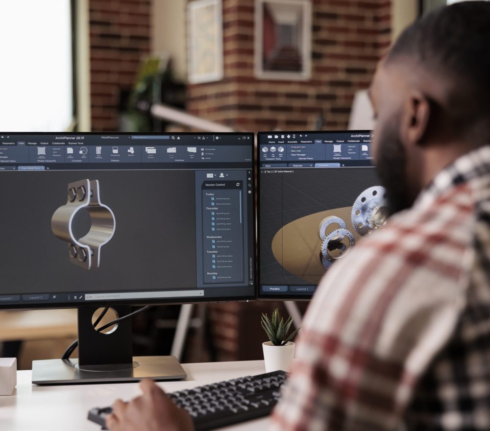 African american developer setting up gears model African american developer setting up gears model on manufacturing software, developing engine product for technical industry innovation. Creating turbine design with industrial cad science.